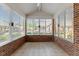 Brick sunroom with many windows and tile floors at 312 Troon Village Ln, Cary, NC 27511