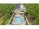 Aerial view of backyard with pool, outdoor dining on deck, and solar panels on the roof at 321 Nortwick Rd, Rolesville, NC 27571