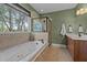 Full bathroom featuring a soaking tub with tile surround and a separate glass shower at 321 Nortwick Rd, Rolesville, NC 27571