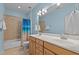 This light and bright bathroom has dual sinks, lots of vanity storage, and a shower/tub combination with colorful curtain at 321 Nortwick Rd, Rolesville, NC 27571