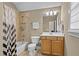 This bathroom offers a shower-tub combination with neutral tile surround, a white toilet and a sink vanity with storage at 321 Nortwick Rd, Rolesville, NC 27571