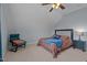 This cozy bedroom features carpeted floors, sloped ceilings, and neutral walls with a colorful quilt and decorative pillows at 321 Nortwick Rd, Rolesville, NC 27571