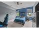 This bright bedroom includes a large window, ceiling fan, and comfortable furniture, creating a welcoming and serene atmosphere at 321 Nortwick Rd, Rolesville, NC 27571