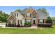 Beautiful two-story home featuring brick and siding, mature landscaping, and a well-manicured lawn at 321 Nortwick Rd, Rolesville, NC 27571