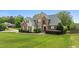 Stately two-story home featuring brick and siding, mature landscaping, and a lush green lawn at 321 Nortwick Rd, Rolesville, NC 27571