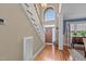 Bright foyer with hardwood floors, staircase, arched window, and views into the dining area at 321 Nortwick Rd, Rolesville, NC 27571