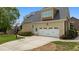 Attached garage with a clean driveway and a basketball hoop, set against a well-manicured lawn at 321 Nortwick Rd, Rolesville, NC 27571