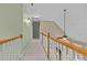 Upstairs hallway with carpet and wood railing overlooking the two-story foyer at 321 Nortwick Rd, Rolesville, NC 27571