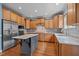 A kitchen with stainless steel appliances, hardwood floors, a kitchen island, and light wood colored cabinets at 321 Nortwick Rd, Rolesville, NC 27571