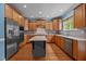 A kitchen with stainless steel appliances, hardwood floors, a kitchen island, and light wood colored cabinets at 321 Nortwick Rd, Rolesville, NC 27571