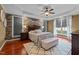 Beautiful bedroom featuring a stone accent wall, tray ceiling, and lots of natural light at 321 Nortwick Rd, Rolesville, NC 27571