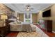 Beautiful main bedroom with tray ceiling, ceiling fan, and cherry-stained hardwood floors at 321 Nortwick Rd, Rolesville, NC 27571
