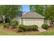 Backyard storage shed with ramp access surrounded by trees and vegetation at 321 Nortwick Rd, Rolesville, NC 27571