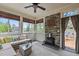 Light filled sunroom featuring a stone fireplace, multiple windows, and a comfortable sitting area perfect for relaxation at 321 Nortwick Rd, Rolesville, NC 27571