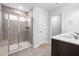 Modern bathroom featuring a glass-enclosed shower and double vanity sinks at 3231 Pelican Ln, Durham, NC 27703