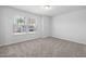 Bright bedroom featuring a window, neutral walls and carpet flooring, offering a serene and comfortable space at 3231 Pelican Ln, Durham, NC 27703