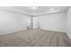 Carpeted room with tray ceilings and multiple doorways at 3231 Pelican Ln, Durham, NC 27703
