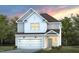 Charming two-story home with a two-car garage, green lawn and beautiful architectural details at 3231 Pelican Ln, Durham, NC 27703