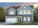 Charming two-story home with a two-car garage, landscaped yard, and welcoming entryway at 3231 Pelican Ln, Durham, NC 27703