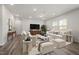 Bright living room with neutral décor, plush seating, and ample natural light at 3231 Pelican Ln, Durham, NC 27703