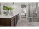 Modern bathroom showcasing a dual sink vanity, walk-in glass shower, and a view of the main bedroom at 3233 Pelican Ln, Durham, NC 27703