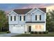 Charming two-story home boasts a manicured lawn, attached garage, and inviting front porch at 3233 Pelican Ln, Durham, NC 27703