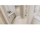 Modern bathroom with double sinks, white cabinets, and access to a walk-in closet at 334 Beacon Dr, Pittsboro, NC 27312