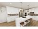Bright kitchen with white cabinets, stainless steel appliances, and a spacious island with bar seating at 334 Beacon Dr, Pittsboro, NC 27312