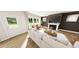 Bright living room with hardwood floors, fireplace and access to the outdoor via white door at 334 Beacon Dr, Pittsboro, NC 27312
