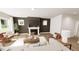 Cozy living room with a fireplace, hardwood floors, and comfortable seating arrangement at 334 Beacon Dr, Pittsboro, NC 27312