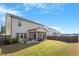Spacious backyard featuring a screened-in porch, a well-maintained lawn, and a privacy fence at 3422 Norway Spruce Rd, Raleigh, NC 27616