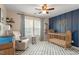 Bedroom features a crib, glider, and blue accent wall with custom name decor at 3422 Norway Spruce Rd, Raleigh, NC 27616