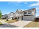 Inviting two-story home with a spacious driveway, a front porch, and manicured lawn at 3422 Norway Spruce Rd, Raleigh, NC 27616