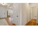 Clean hallway with hardwood floors, connecting to a bright living space and bathroom at 3422 Norway Spruce Rd, Raleigh, NC 27616