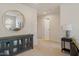 Open hallway with hardwood floors, mirror and table at 3422 Norway Spruce Rd, Raleigh, NC 27616