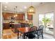 Eat-in kitchen with stainless steel appliances, island, and sliding doors to the patio at 3422 Norway Spruce Rd, Raleigh, NC 27616