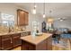 Charming kitchen boasts stainless appliances, an island and eat-in dining area at 3422 Norway Spruce Rd, Raleigh, NC 27616