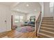 Inviting living room with hardwood floors, a staircase, and ample natural light from the windows at 3422 Norway Spruce Rd, Raleigh, NC 27616