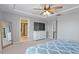 Spacious main bedroom with a ceiling fan, television and ensuite bathroom featuring a glass enclosed shower at 3422 Norway Spruce Rd, Raleigh, NC 27616