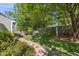 Landscaped backyard with a stone path and mature trees at 3519 Streams Of Fields Dr, Raleigh, NC 27604
