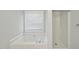 Bright bathroom featuring a soaking tub under a window and a separate walk-in shower at 3519 Streams Of Fields Dr, Raleigh, NC 27604