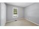 This bedroom has neutral carpeting and a window providing natural light at 3519 Streams Of Fields Dr, Raleigh, NC 27604