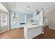 Charming kitchen area features white cabinetry, a peninsula island, and a view of the breakfast nook at 3519 Streams Of Fields Dr, Raleigh, NC 27604