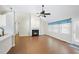 Open-concept space includes a living room with fireplace, a ceiling fan, and laminate floors at 3519 Streams Of Fields Dr, Raleigh, NC 27604