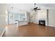 Open-concept space features a living room with fireplace, a ceiling fan, and access to the kitchen at 3519 Streams Of Fields Dr, Raleigh, NC 27604