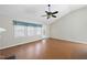Bright living room with a vaulted ceiling, fan, laminate floors, and windows offering plenty of natural light at 3519 Streams Of Fields Dr, Raleigh, NC 27604