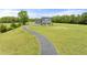 Expansive property featuring a two-story home, a long driveway, and an outbuilding on a sprawling lawn at 3805 Euliss Rd, Burlington, NC 27215