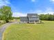 Stunning aerial view of a two-story home with a large yard, outbuilding, and beautiful surroundings at 3805 Euliss Rd, Burlington, NC 27215