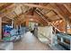 Unfinished attic space with exposed beams and a stairway at 3805 Euliss Rd, Burlington, NC 27215