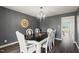 Well-lit dining room with a sophisticated chandelier and large table with white chairs at 3805 Euliss Rd, Burlington, NC 27215